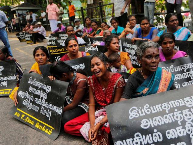 Family members of ethnic Tamil detainees sit for a silent protest in Colombo, Sri Lanka, Wednesday, Oct. 14, 2015. hindu