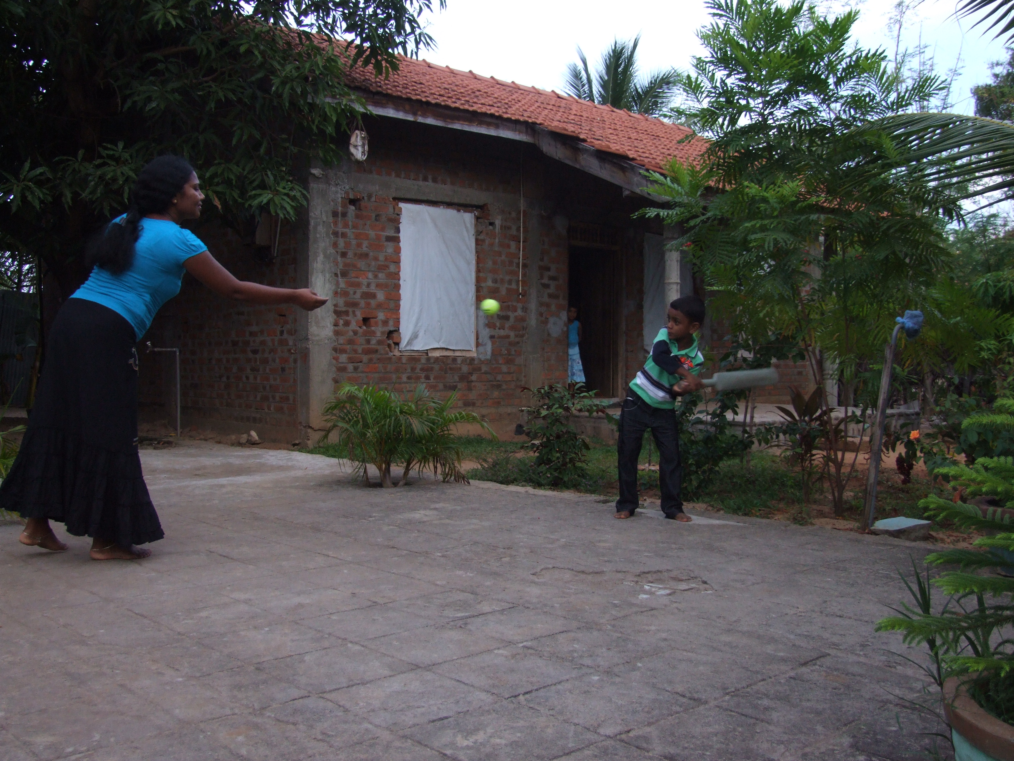 Playing cricket in courtyard